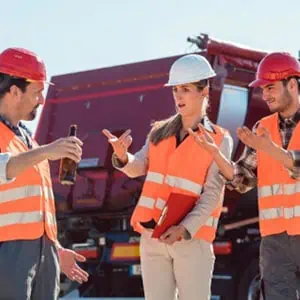 Three construction workers are talking to each other - DC Nguyen Law
