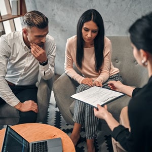 Couple discussing divorce documents with a lawyer - DC Nguyen Law