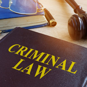 A gavel and a book titled 'CRIMINAL LAW' on a table, Washington Misdemeanor Court Appearance